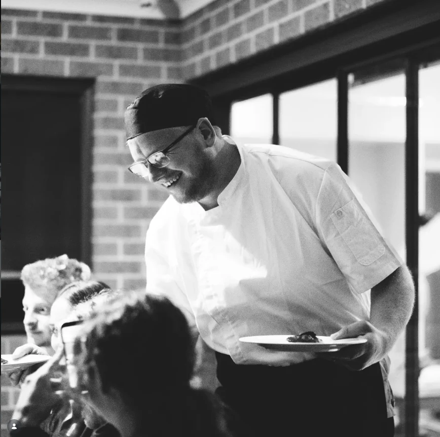 Chef Justin Instagram post showing Chef Justin serving guests