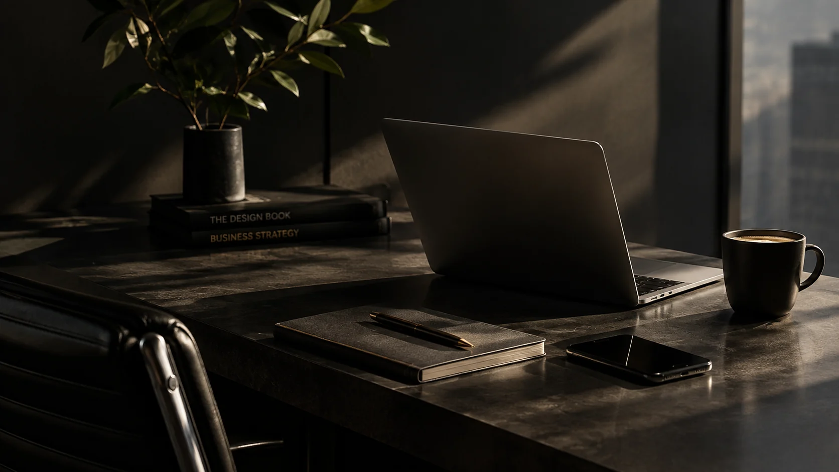 Dark premium workspace with a laptop, plant and coffee on a stone desk